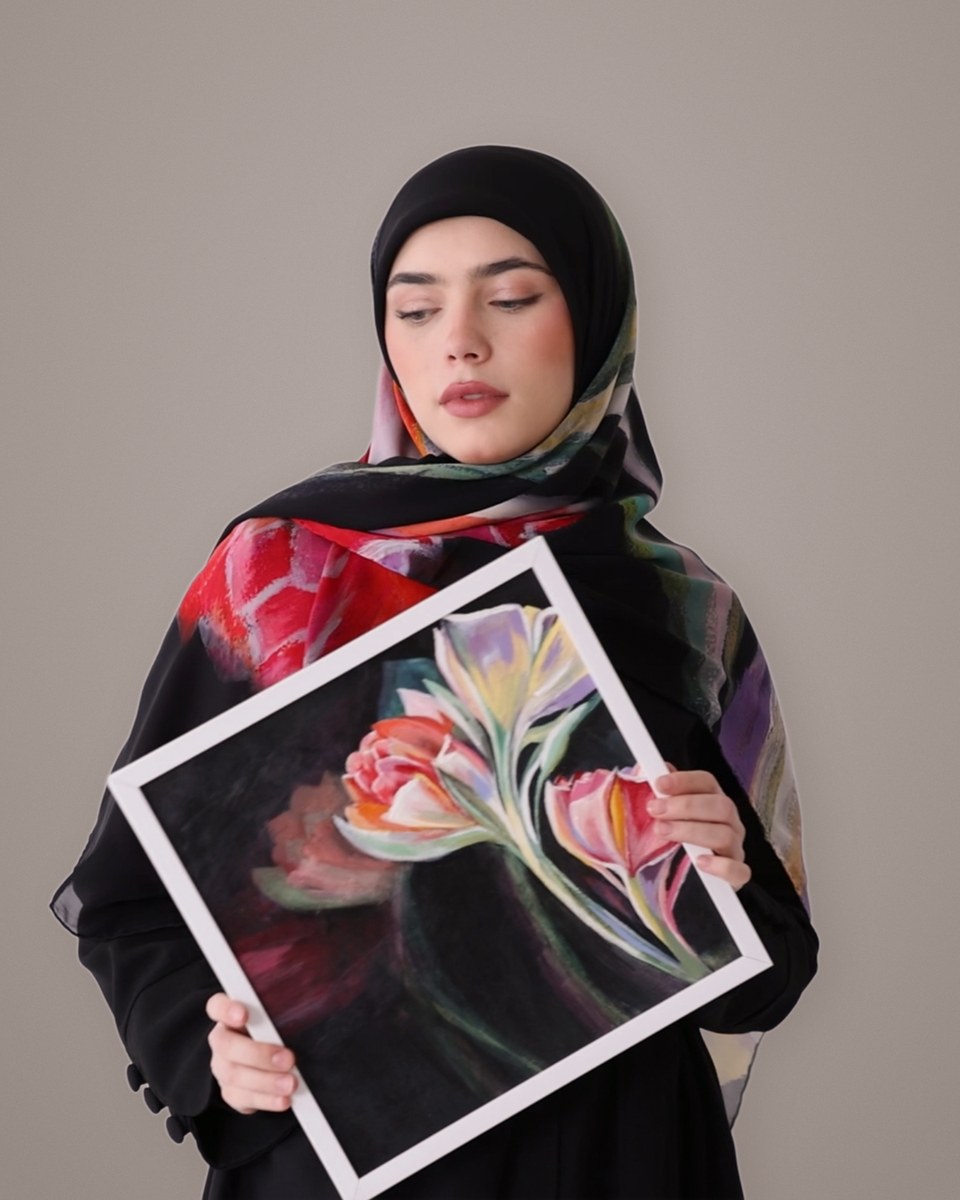 The model wearing the Noir Tulip silk scarf, holding the original painting