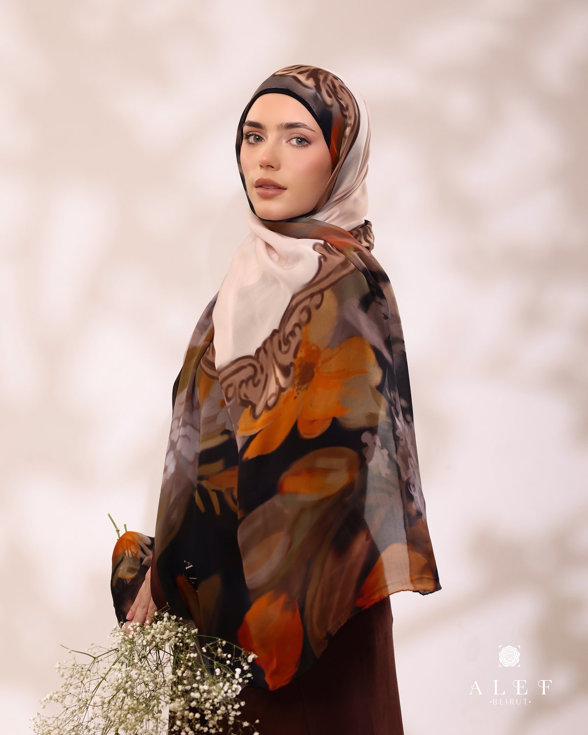 The Amber Baroque silk scarf, holding baby's breath