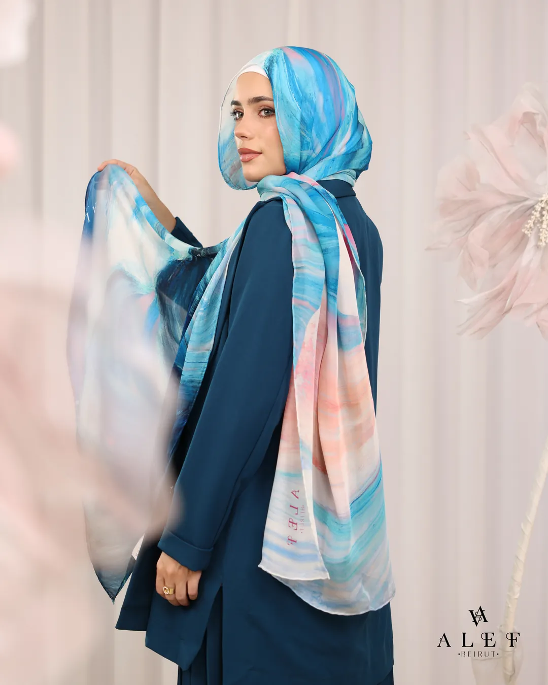 Aqua silk over a teal jacket, from behind
